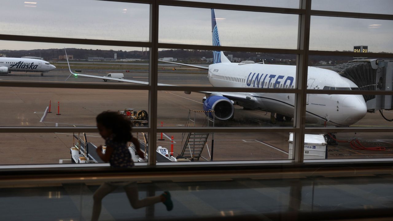 A young passenger runs through a hallway at Ronald Reagan Washington National Airport in Arlington, Virginia on November 21, 2023.