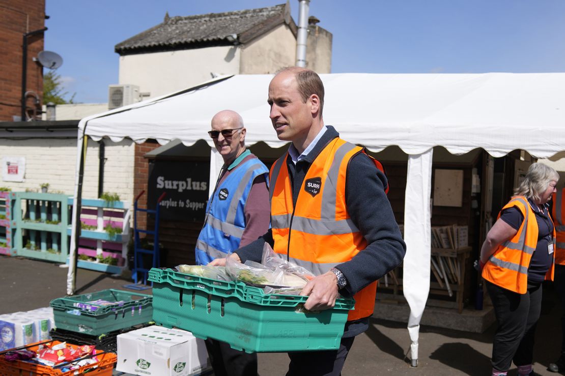 William helps load trays of food into vans for distribution. 