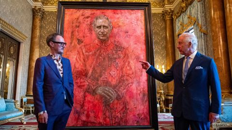 LONDON, ENGLAND - MAY 14: Artist Jonathan Yeo and King Charles III stand in front of the portrait of the King Charles III by artist Jonathan Yeo as it is unveiled in the blue drawing room at Buckingham Palace on May 14, 2024 in London, England. The portrait was commissioned in 2020 to celebrate the then Prince of Wales's 50 years as a member of The Drapers' Company in 2022. The artwork depicts the King wearing the uniform of the Welsh Guards, of which he was made Regimental Colonel in 1975. The canvas size - approximately 8.5 by 6.5 feet when framed - was carefully considered to fit within the architecture of Drapers' Hall and the context of the paintings it will eventually hang alongside. Jonathan Yeo had four sittings with the King, beginning when he was Prince of Wales in June 2021 at Highgrove, and later at Clarence House. The last sitting took place in November 2023 at Clarence House. Yeo also worked from drawings and photographs he took, allowing him to work on the portrait in his London studio between sittings. (Photo by Aaron Chown-WPA Pool/Getty Images)