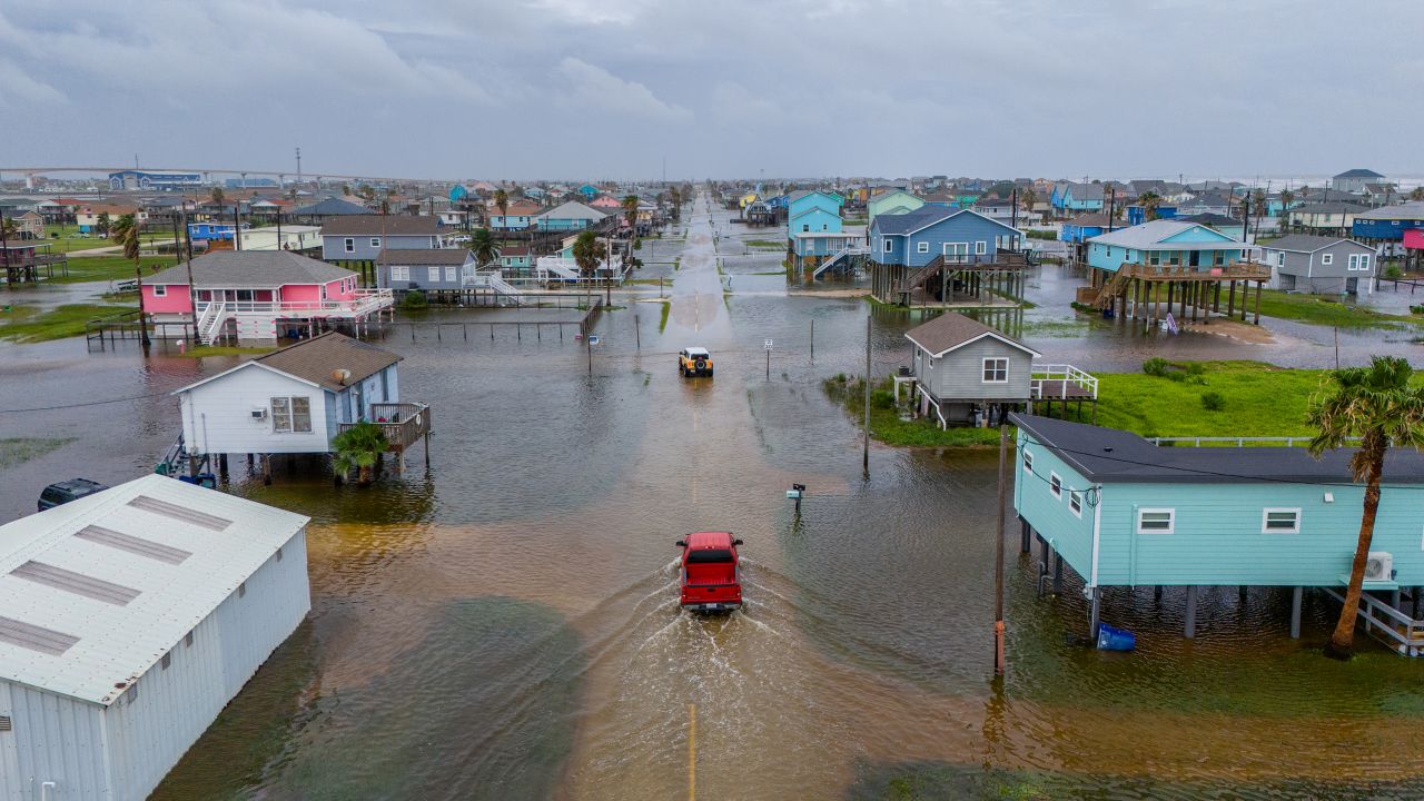 SURFSIDE BEACH, TEXAS - JUNE 19: In this aerial image, vehicles drive through flooded neighborhoods on June 19, 2024 in Surfside Beach, Texas. Storm Alberto, the first named tropical storm of the hurricane season, was located approximately 305 miles south-southeast of Brownsville, Texas and formed earlier today in the Southwestern Gulf of Mexico. The storm has produced heavy winds and rainfall, creating flooding within various communities along Texas coastlines. (Photo by Brandon Bell/Getty Images)