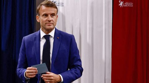 France's President Emmanuel Macron leaves the polling booth prior to cast his vote in the first round of parliamentary elections at a polling station in Le Touquet, northern France on June 30, 2024. A divided France is voting in high-stakes parliamentary elections that could see the anti-immigrant and eurosceptic party of Marine Le Pen sweep to power in a historic first. The candidates formally ended their frantic campaigns at midnight June 28, with political activity banned until the first round of voting.