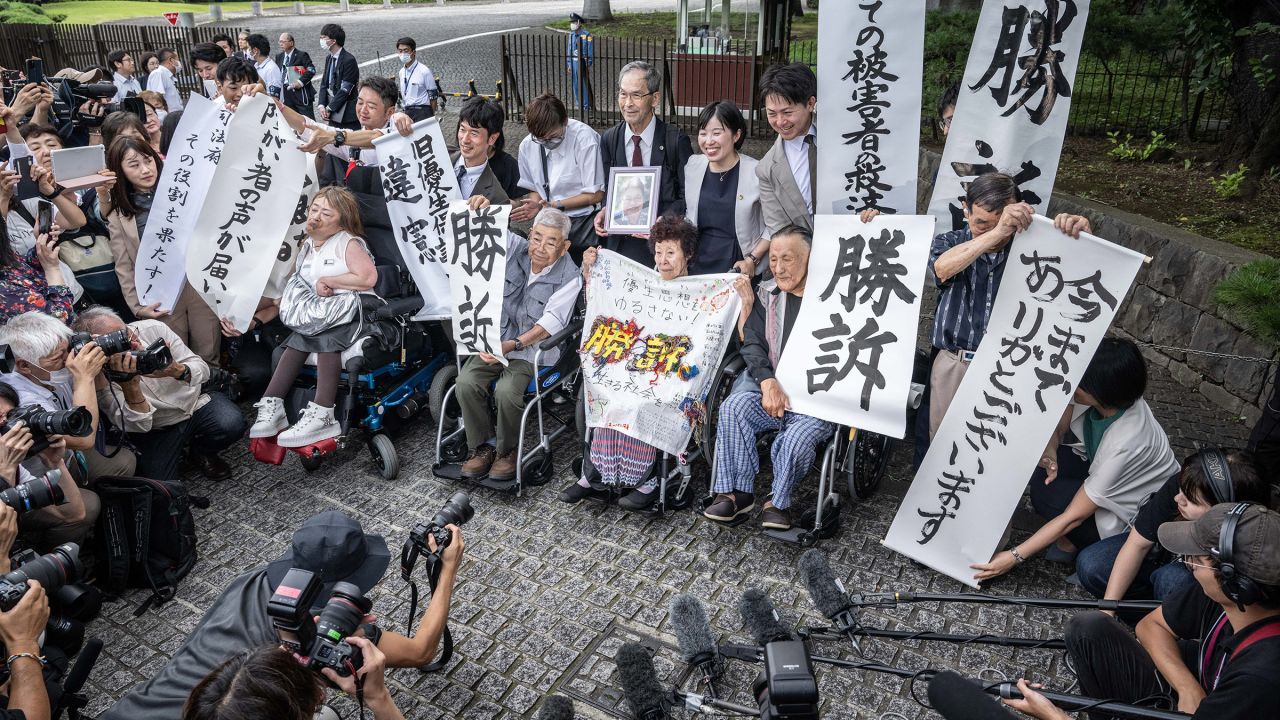 Victims of forced sterilization under a now-defunct eugenics law, celebrate with lawyers and supporters outside of the Supreme Court of Japan in Tokyo on July 3, 2024. Japan's top court ruled that a defunct eugenics law under which around 16,500 people were forcibly sterilized between 1948 and 1996 was unconstitutional, local media reported.