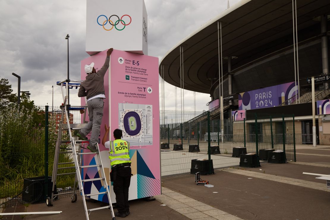 PARIS, FRANCE - JULY 3: Workers prepare an information board outside Stade de France in Saint Denis on July 3, 2024 in Paris, France. The Paris 2024 Olympic Games will run from July 26 to August 11. (Photo by Pierre Crom/Getty Images)