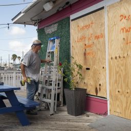 A worker boards up windows at a ice cream parlor ahead of Hurricane Beryl's landfall in Port Aransas, Texas, US, on Saturday, July 6, 2024. Beryl is expected to reach southern Texas by Sunday night or Monday morning, regaining hurricane status as it crosses over the toasty Gulf of Mexico.