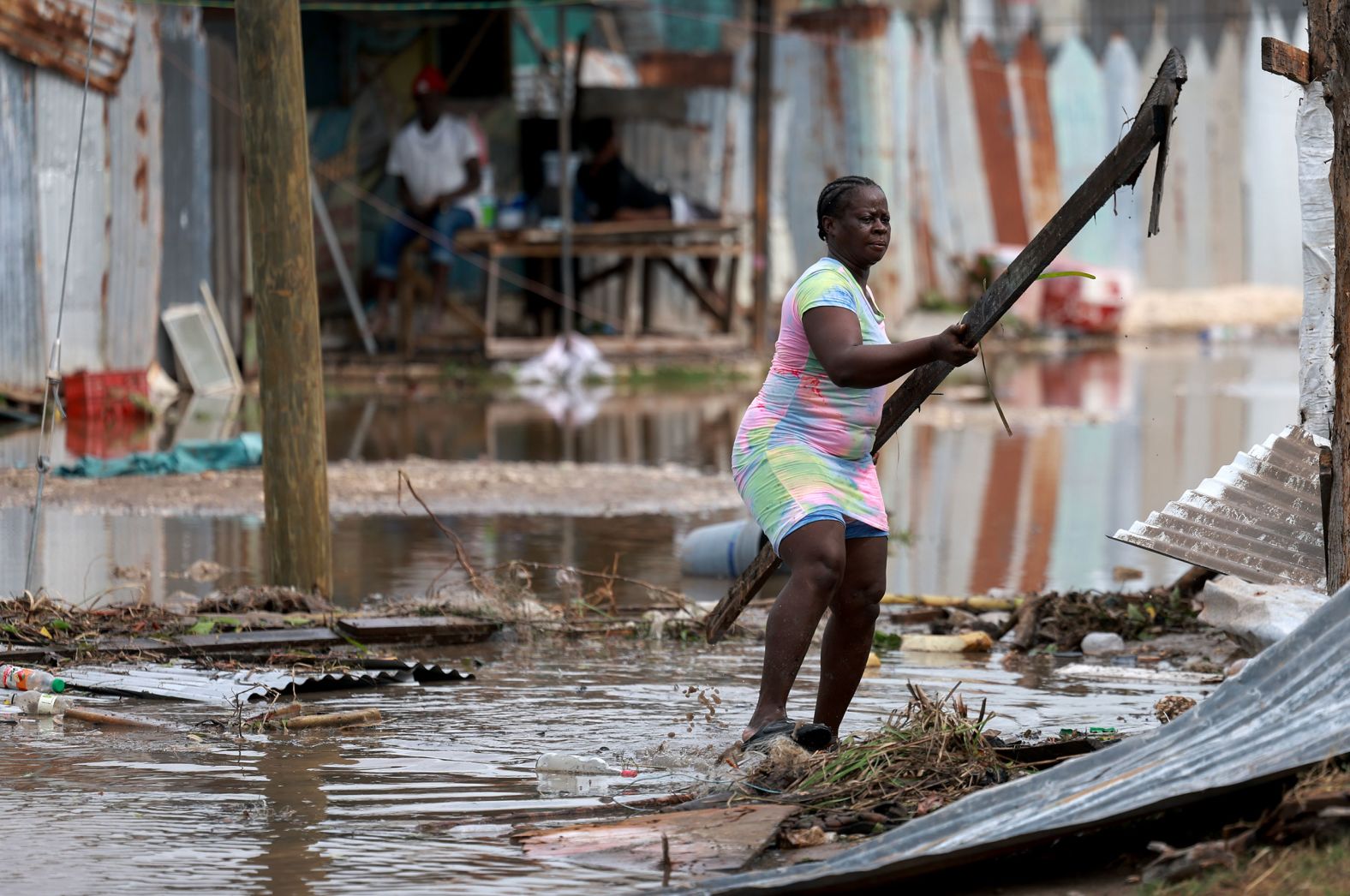 Simone Francis gathers items from her home that were blown away by Hurricane Beryl in Old Harbor, Jamaica, on Thursday.