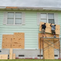 (L-R) Dane Allen and Randy Davis board up apartments ahead of Tropical Storm Beryl's arrival on July 07, 2024 in Corpus Christi, Texas. Tropical Storm Beryl is projected to strengthen into a hurricane by its arrival on Texas shores. The storm is situated southeast of Corpus Christi, Texas, and is projected to intensify with the possibility of rainfall flooding, accelerated winds, and tornados.