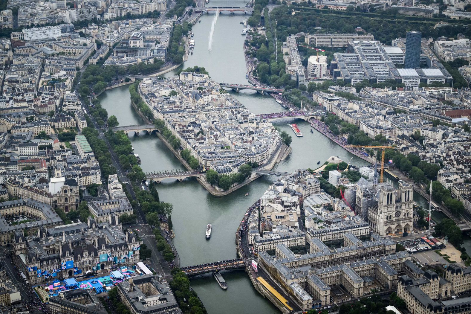 This aerial photo shows the Notre Dame cathedral as boats pass by on the Seine. As part of the ceremony, <a href="https://www.cnn.com/sport/live-news/paris-olympics-2024-opening-ceremony-seine#h_f4e1c79bb5cf9047ee74b7e7515bfe52">the bells of Notre Dame rang for the first time</a> since the iconic cathedral was gutted by fire in 2019. It is 90% restored.