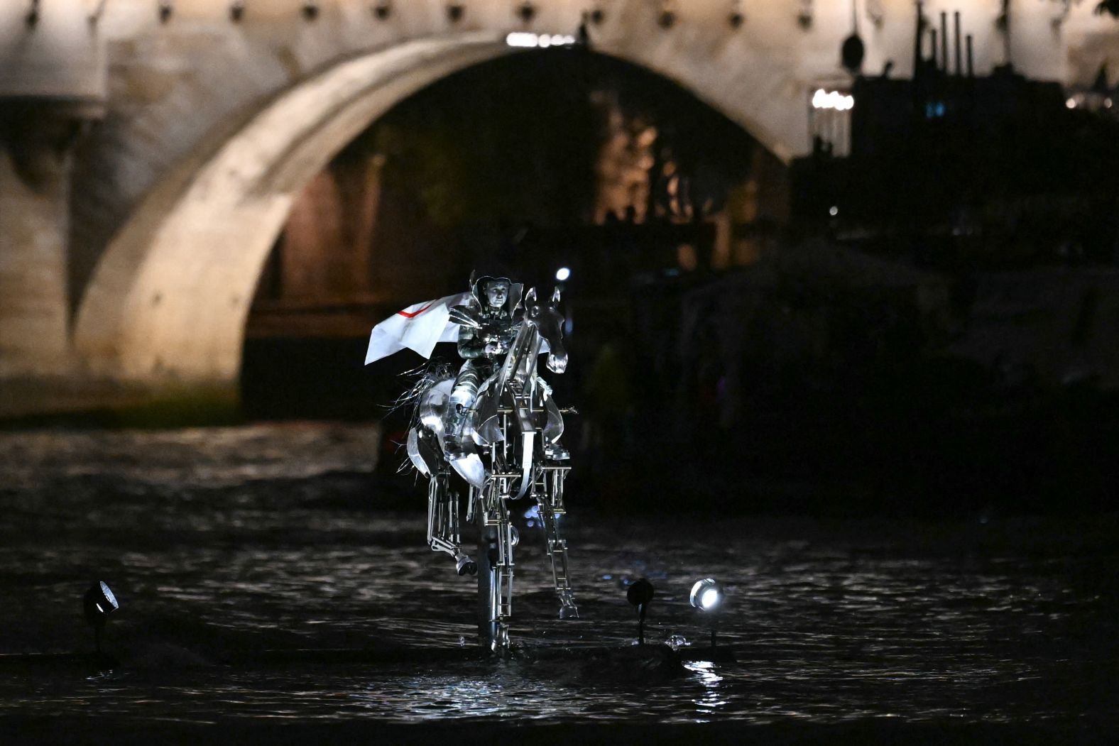 Issert wore the Olympic flag as she <a href="https://www.cnn.com/sport/live-news/paris-olympics-2024-opening-ceremony-seine#h_8b8665772097d280bfa8418324861f82">rode a metal horse aboard a boat that traveled down the Seine River.</a>