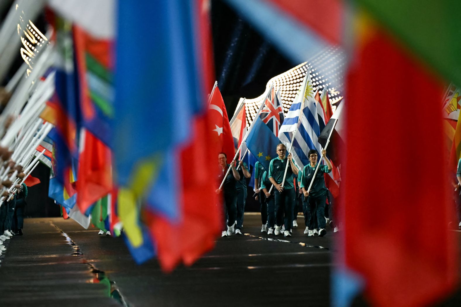 Volunteers carry flags on the Jena Bridge, which crosses the Seine River in Paris.