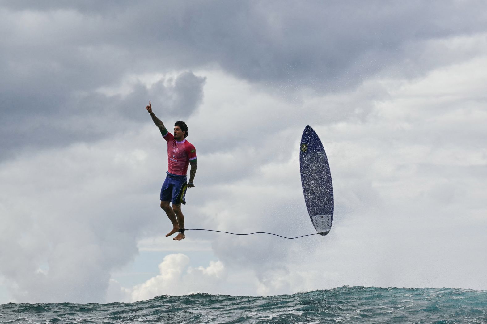 Brazilian surfer Gabriel Medina leaps from his surfboard and raises his finger in the air as he celebrates <a href="https://www.cnn.com/2024/07/30/sport/gabriel-medina-surfer-photo-paris-olympics/index.html">a near-perfect 9.90-scoring wave</a> on Monday, July 29. It was the highest-scoring wave in Olympic history.