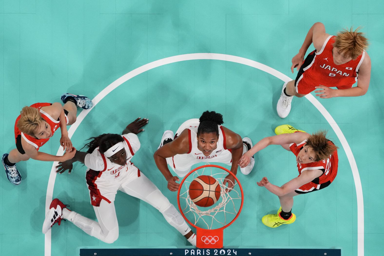 From left, Japan's Saori Miyazaki, the United States' Kahleah Copper, the United States' Alyssa Thomas, Japan's Saki Hayashi and Japan's Maki Takada watch the ball go through the hoop during their first basketball game in Paris on July 29. <a href="https://www.cnn.com/sport/live-news/paris-olympics-news-2024-07-29#h_84e113914114770876ceaa3036a15320">Team USA won 102-76</a> in what was a rematch of the gold-medal game three years ago. The United States has won 56 consecutive Olympic games.