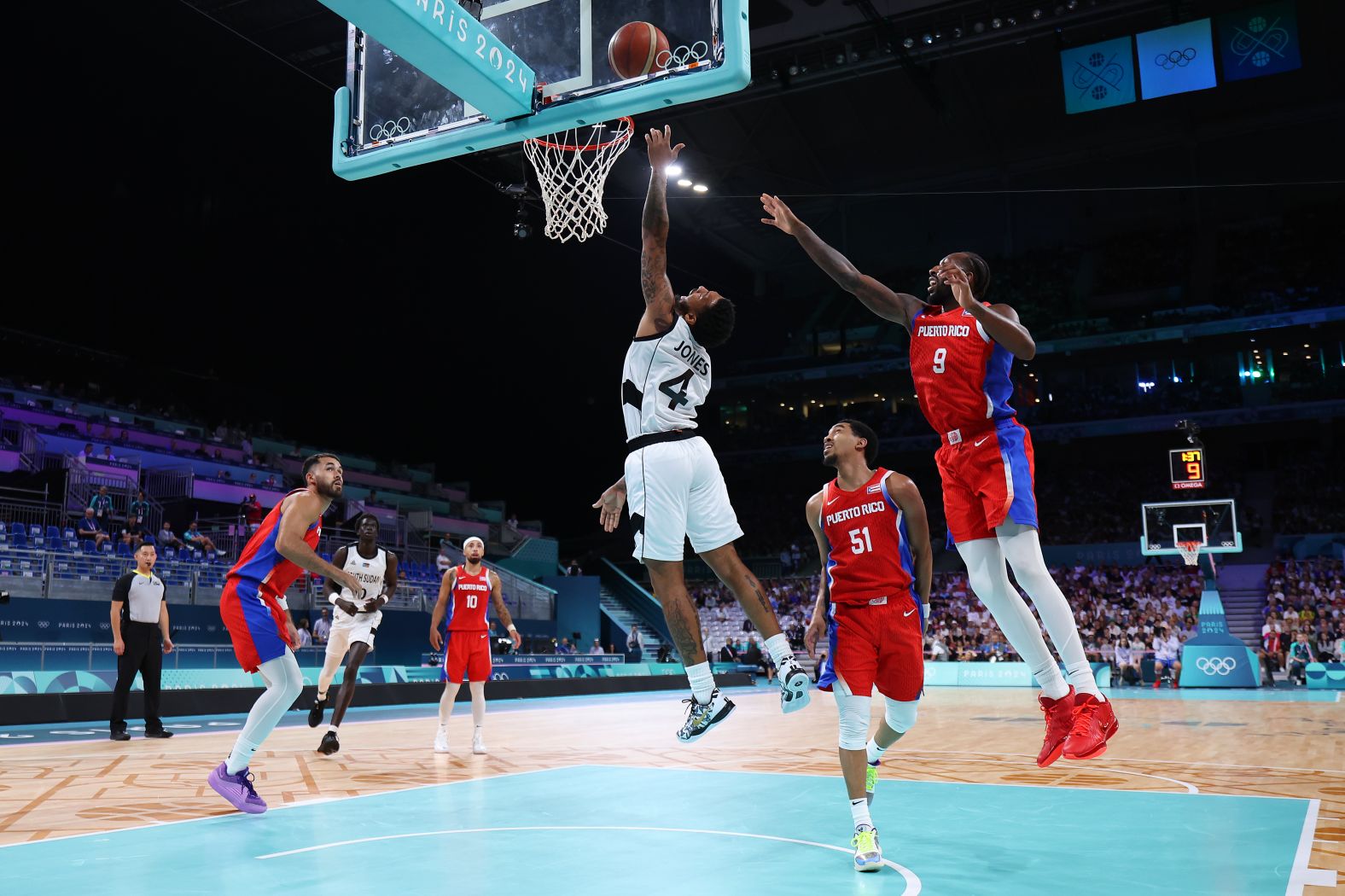 South Sudanese basketball player Carlik Jones drives to the basket during a game against Puerto Rico on July 28. South Sudan claimed a <a href="https://www.cnn.com/sport/live-news/paris-olympics-news-2024-07-28#h_c0270c5dd556a54f630fdf3c800a1bfd">historic victory</a> in its first-ever Olympic men's game, winning 90-79.