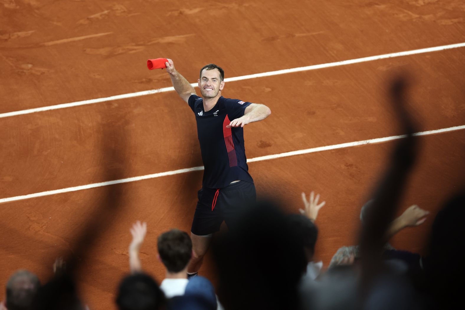 British tennis player Andy Murray throws his sweatband into the crowd after he and doubles partner Dan Evans <a href="https://www.cnn.com/sport/live-news/paris-olympics-news-2024-07-30#h_2282ca8d3cc57b451230e7eae1a6353f">advanced to the quarterfinals</a> with a dramatic win over Belgium's Sander Gille and Joran Vliegen on July 30. Murray and Evans won 6-3, 6-7, 11-9. Murray has said this tournament will be the last of his legendary career.