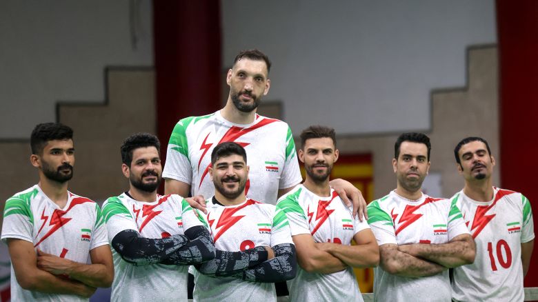 Iranian athlete Morteza Mehrzad (top C) poses for a picture with his teammates during a training session of Iran's national sitting volleyball team in Tehran on July 20, 2024 ahead of the 2024 Paris Paralympics. Iran's sitting volleyball star, Morteza Mehrzad, has battled countless challenges due to his towering height, but now he's ready to help propel his team to another victory at the Paris Paralympics. (Photo by ATTA KENARE / AFP) (Photo by ATTA KENARE/AFP via Getty Images)