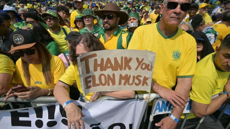 Supporters of former Brazilian President Jair Bolsonaro (2019-2022) hold a sign thanking X social media platform owner Elon Musk, during an Independence day rally in Sao Paulo, Brazil on September 7, 2024. (Photo by NELSON ALMEIDA / AFP) (Photo by NELSON ALMEIDA/AFP via Getty Images)