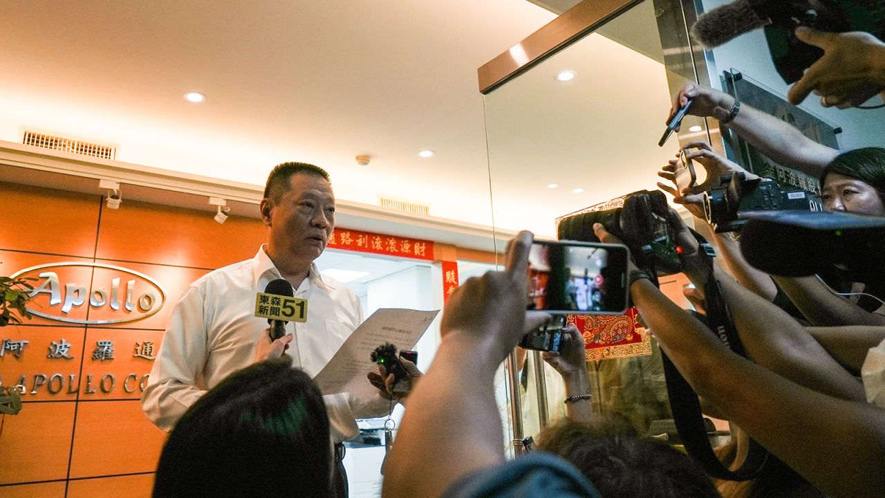 Hsu Ching-kuang (L), head of Taiwanese company Gold Apollo, speaks to the media outside the company's office in New Taipei City on September 18, 2024.