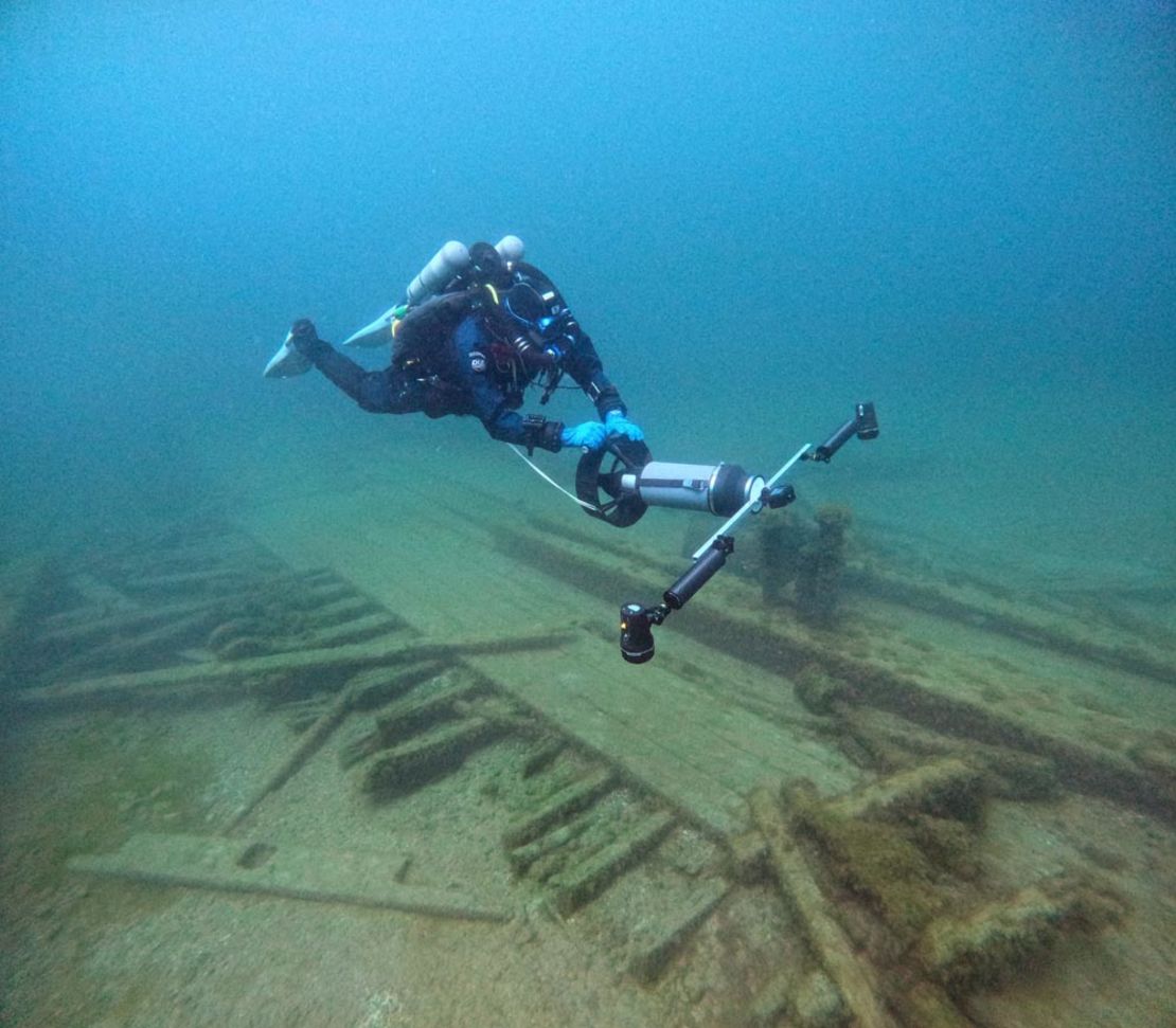 A diver from the Wisconsin Historical Society collects photos for a 3D photogrammetry model of the Muir.