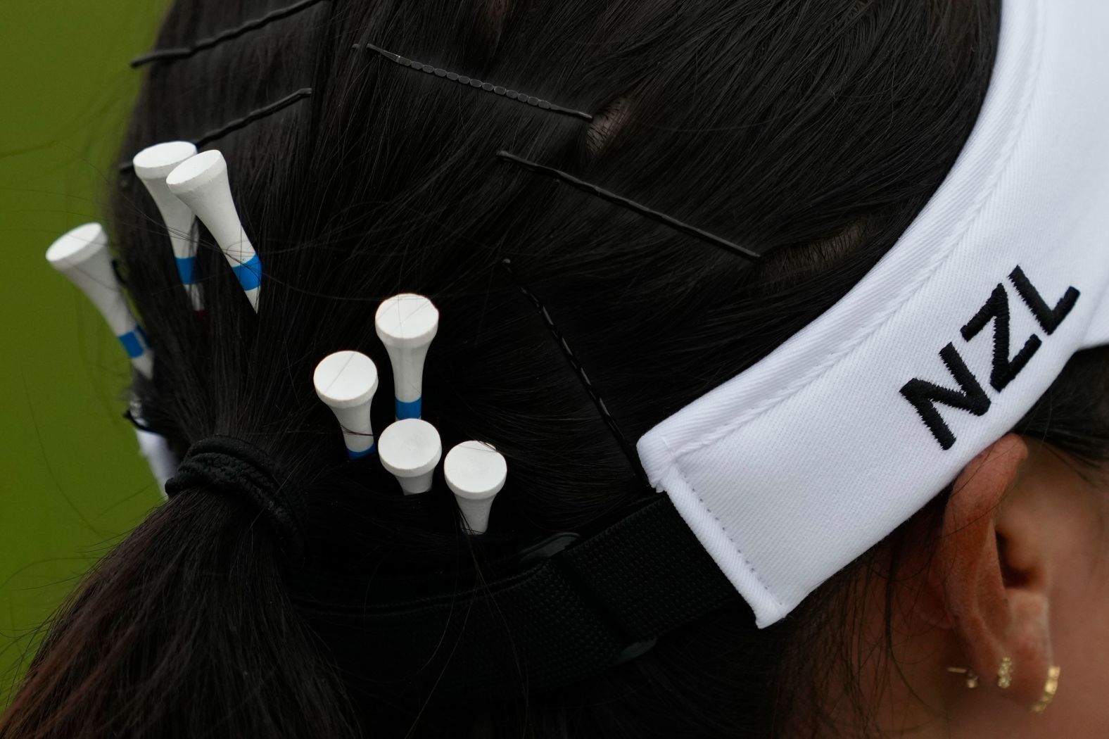 New Zealand's Lydia Ko carries spare tees in her hair during the third round of the women's golf tournament on August 9. Ko and Switzerland’s Morgane Métraux <a href="https://www.cnn.com/sport/live-news/paris-olympics-news-2024-08-09#h_9e0ee093e478c68c24e164409c7f6933">were atop the leaderboard</a> before the fourth and final round.