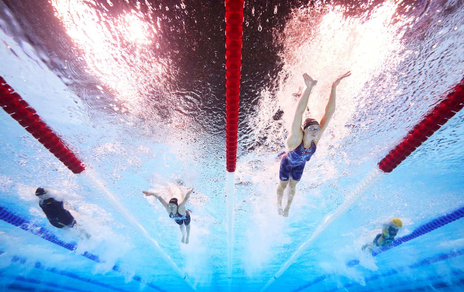 US swimmer Gretchen Walsh, second from right, <a href="https://www.cnn.com/sport/live-news/paris-olympics-news-2024-07-27#h_ebb32299890e7a9cd932e5751ceef68d">set a new Olympic record in the 100-meter butterfly</a> during a semifinal race on July 27. She finished in 55.38 seconds.