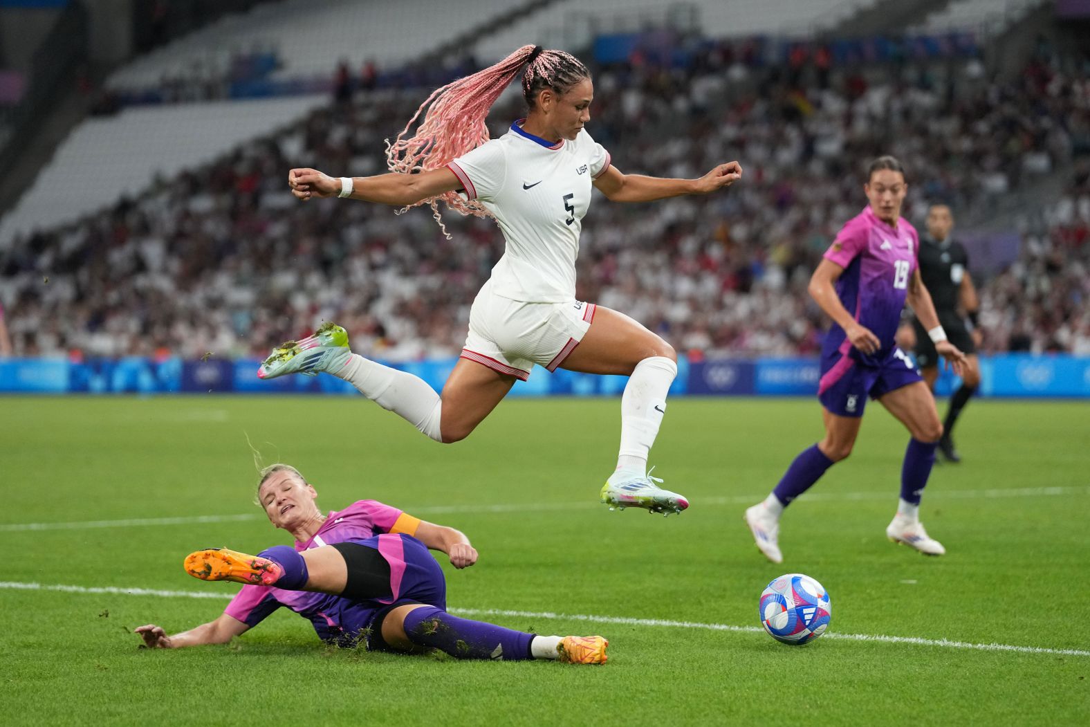 US forward Trinity Rodman jumps over Germany's Alexandra Popp during <a href="https://www.cnn.com/sport/live-news/paris-olympics-news-2024-07-28#h_120d2d453e327133d38d827ba7276d46">the Americans' 4-1 victory</a> on July 28.