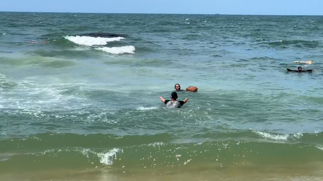 Some Palestinians ventured into the water aid parcels fell into the sea.