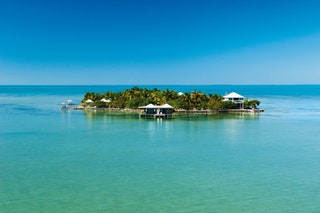 Five kilometres off Ambergris Caye the largest island of the Belizean archipelago Cayo Espanto is a lowlying sandy...