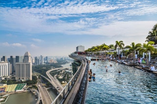 Infinity Pool and Singapore skyline at dusk from Marina Bay Sands Hotel