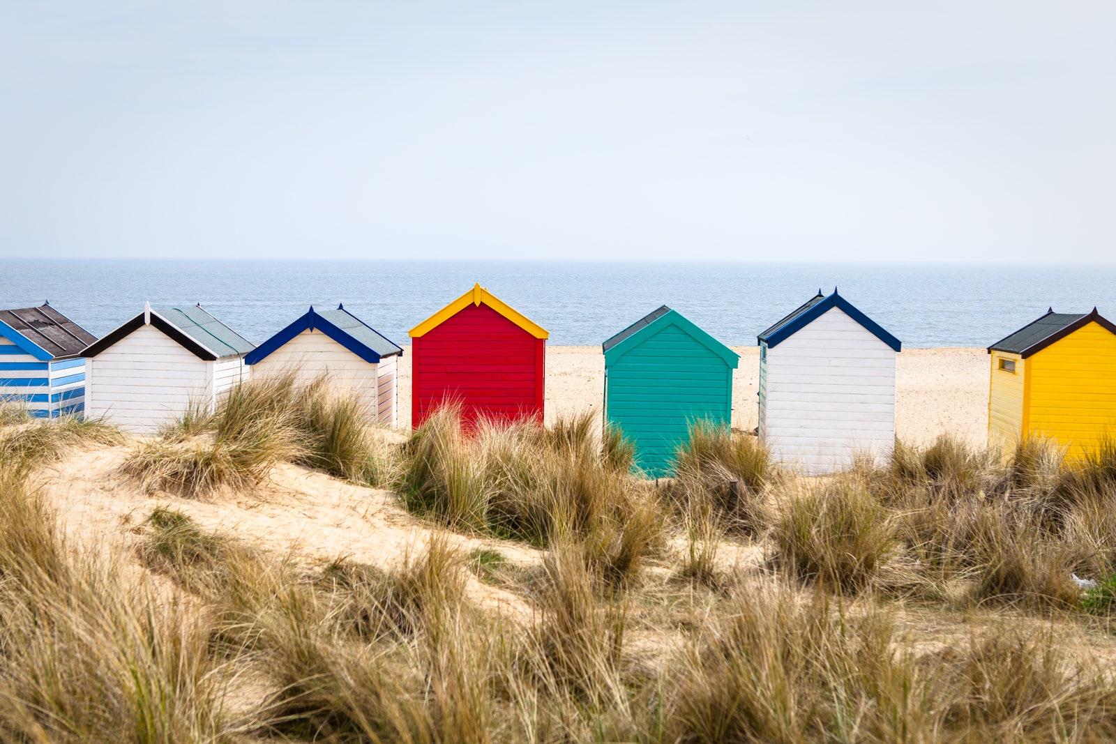 MultiColoured beach huts on sandy beach