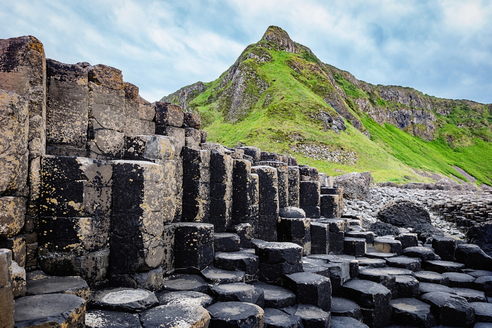 Beautiful Giants Causeway Volcanic Landscape with famous Hexagonal Basalt Columns under dramatic skyscape. Giants...