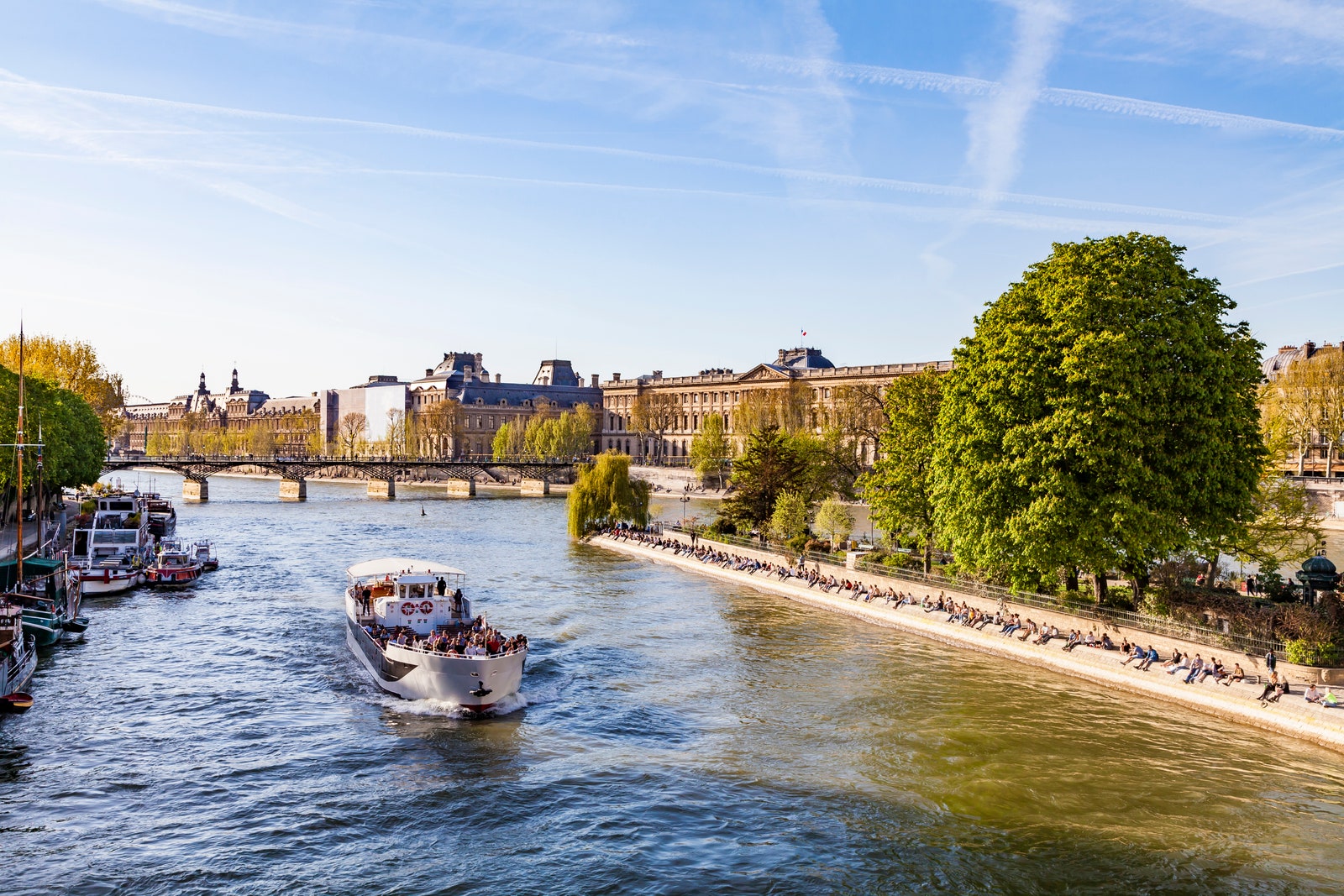 France Paris Tourist boat on Seine river with Louvre in background