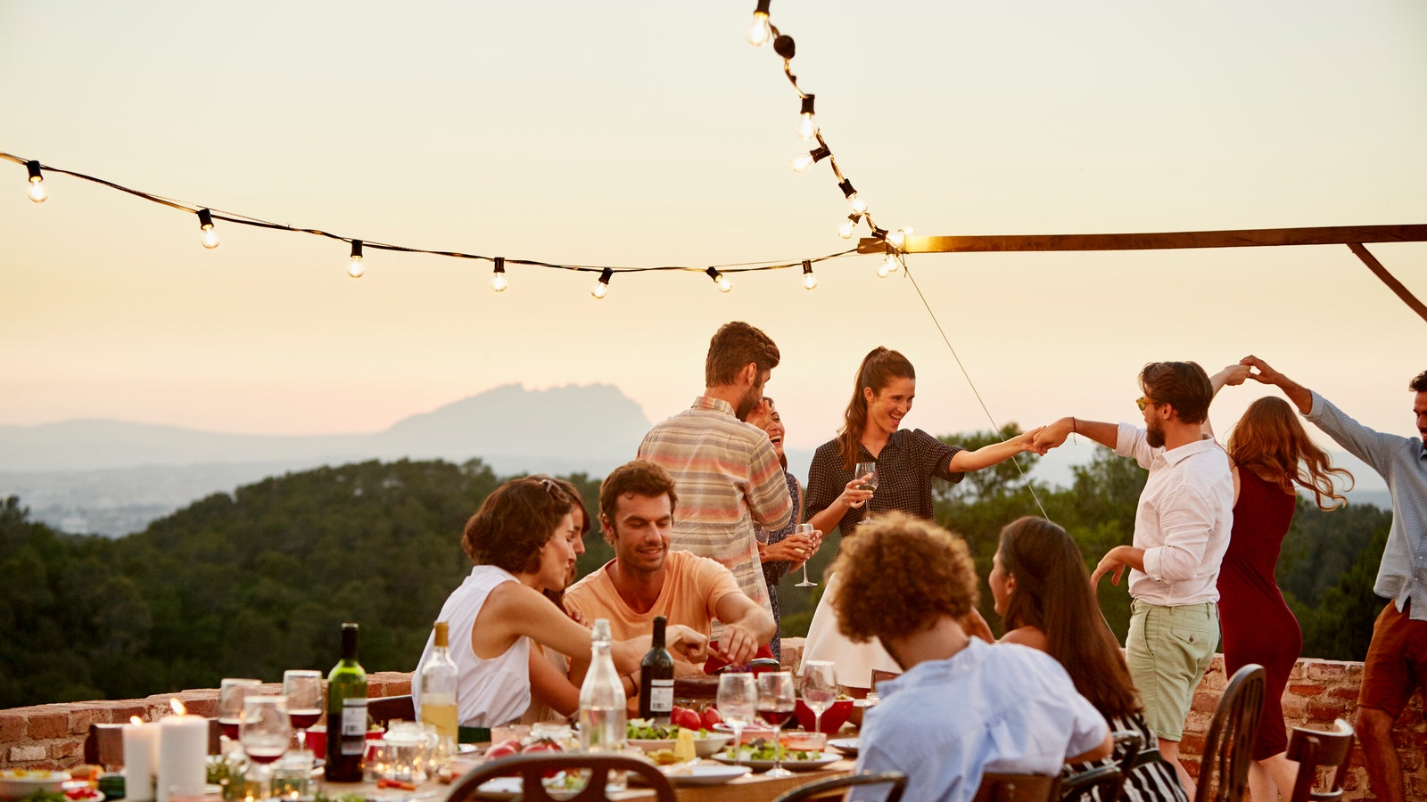 Multi ethnic friends enjoying at patio during social gathering