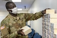 Cadet Serigne Cisse, 374th Financial Management Support Unit officer candidate, stacks play currency for Diamond Saber at Fort McCoy, Wisconsin, Aug. 14, 2021. Diamond Saber is a U.S. Army Reserve-led exercise that incorporates participation from all components and joint services, and it prepares finance and comptroller Soldiers on the warfighting functions of funding the force, payment support, disbursing operations, accounting, fiscal stewardship, auditability and data analytics.