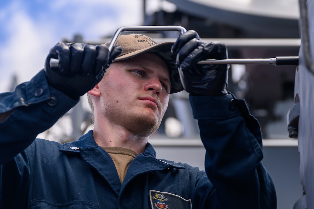 FC2 Carter Smith maintains a Phalanx close-in weapons system aboard USS Gridley (DDG 101).