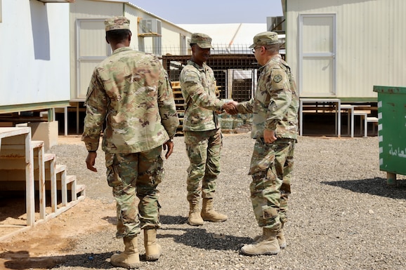 Army senior leader shakes hands with HHC commander at ALOC.