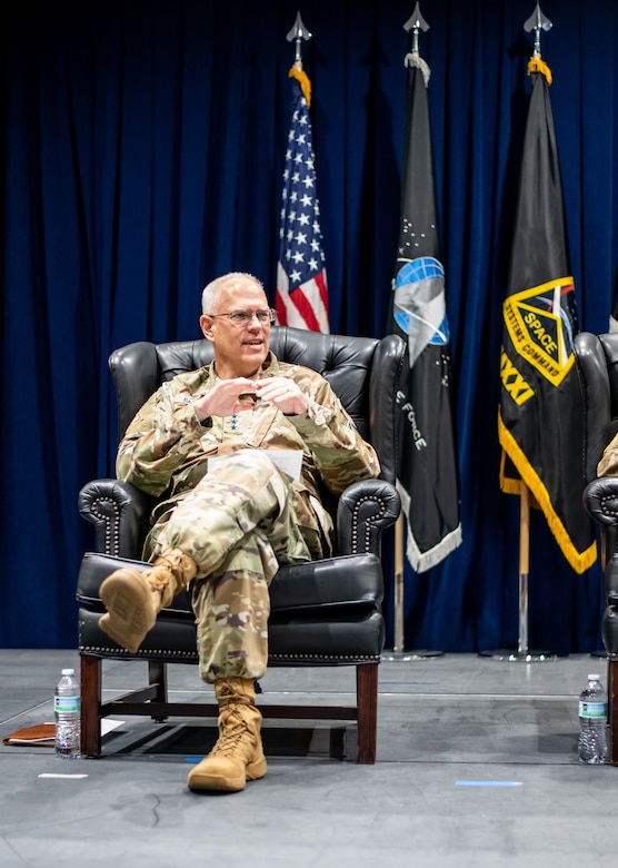 A person speaks while sitting in a chair.