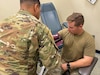 : U.S. Army Reserve Sgt. Jeremy Porterie, a behavioral health specialist assigned to the 7210th Medical Support Unit out of San Antonio, Texas, checks the blood pressure of a Soldier during Mobilization Exercise Level III at the Soldier Readiness Processing Center in Fort Riley, Kan., (insert date here). Army Reserve Medical Command-based Soldiers operated in tandem with Irwin Army Community Hospital to process and validate over 2,200 Soldiers from Active, Guard and Reserve Components in a span of seven days. (U.S. Army Reserve photo by Lt. Col. Joseph Mangiameli)