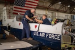 From left, David Plemmons and Michael Hefler, 12th Maintenance Squadron electronics mechanics, replace a wiring harness in a T-6 Texan II at Joint Base San Antonio-Randolph, Texas, Sept. 5, 2024. (U.S. Air Force Photo by Jonathan R. Mallard)