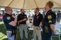 NCIS personnel speak with local law enforcement officers.