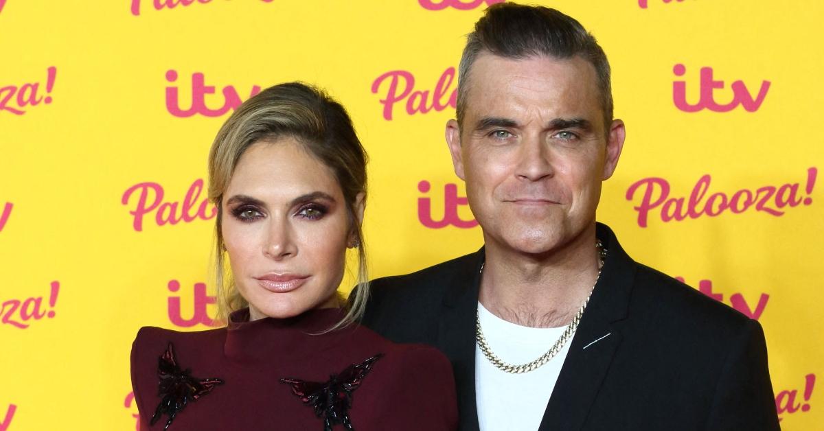 Robbie Williams (R) and wife Ayda Field 