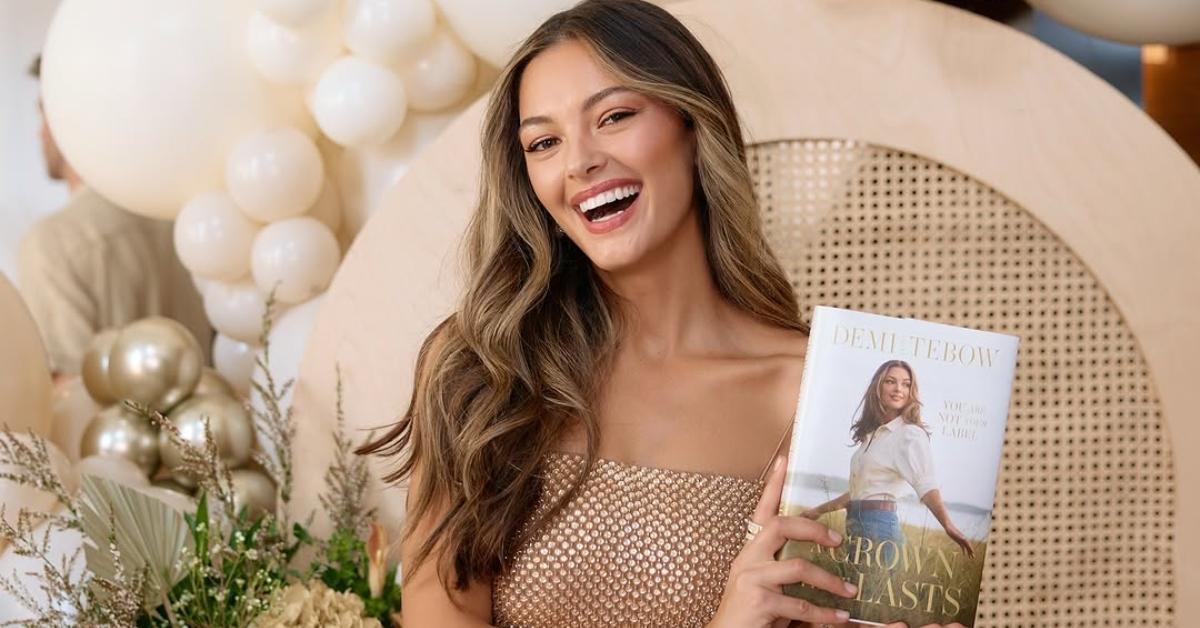 Demi-Leigh Tebow holds up her book