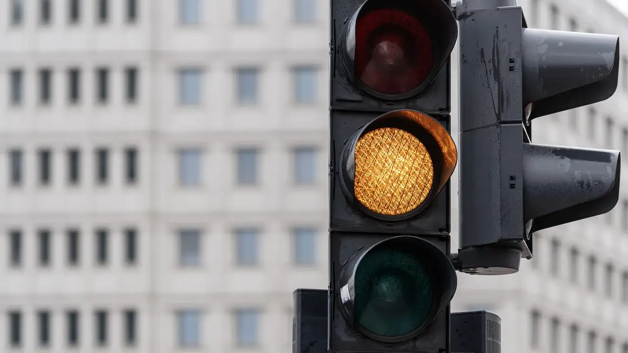 Is it ever okay to drive through a yellow light? Here’s what happens if you do