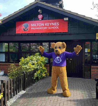 Bernie the bear standing in front of school