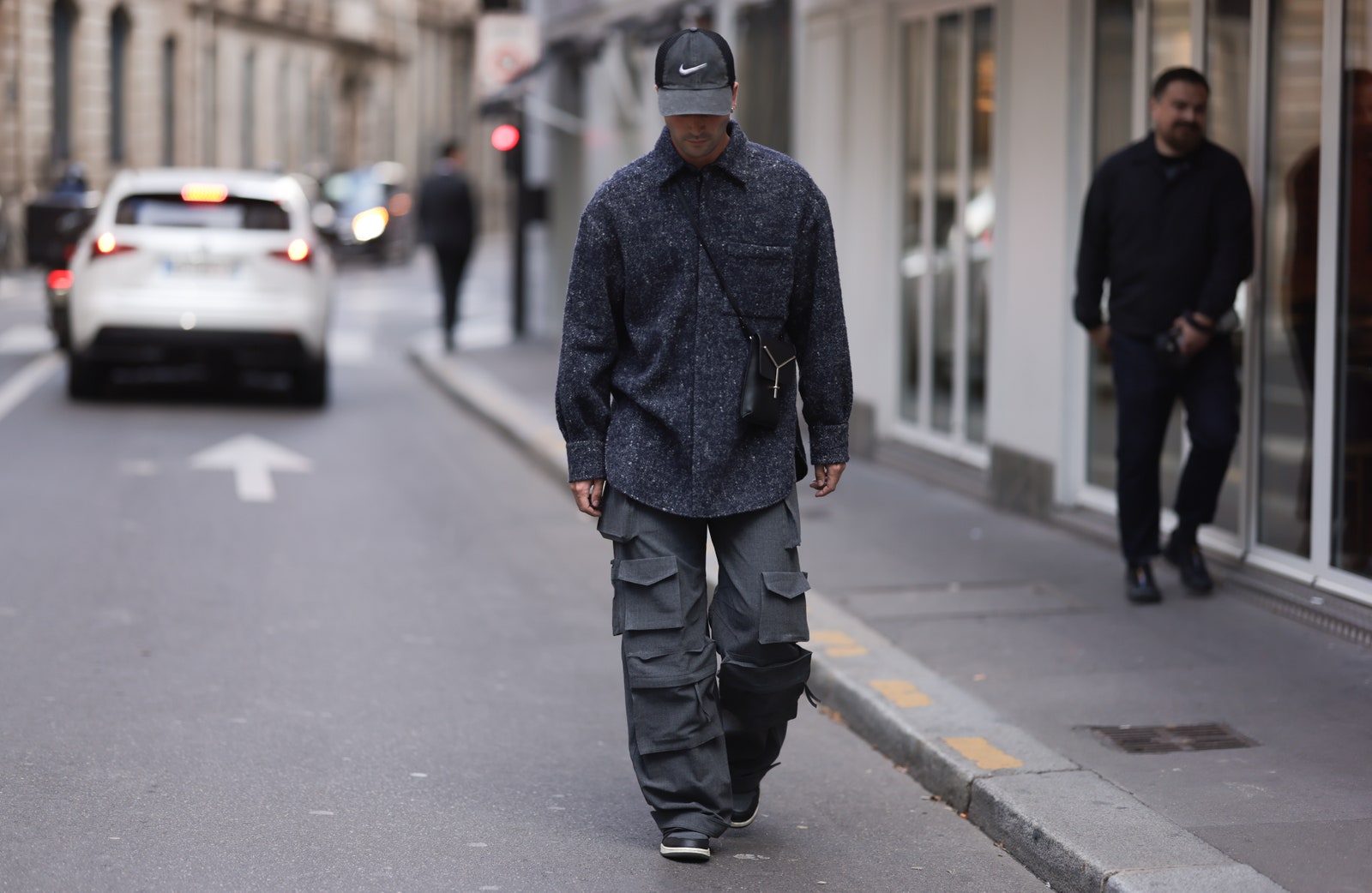 PARIS FRANCE  SEPTEMBER 29 Marc Forne is seen wearing grey Nike cap grey melange wool jacket black leather crossbody bag...