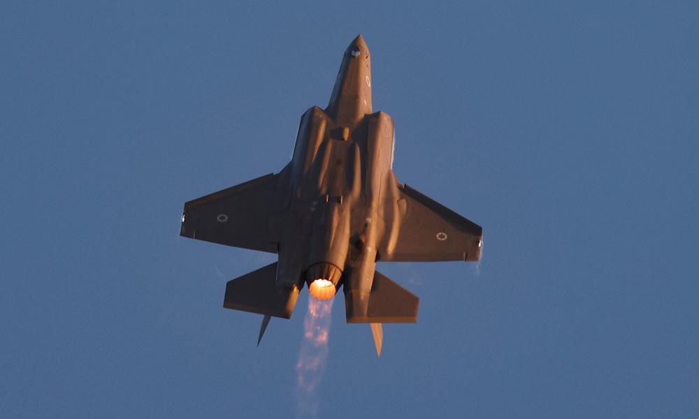 A fighter jet pointing upwards in flight