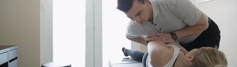 Chiropractor administering treatment to a female patient. 