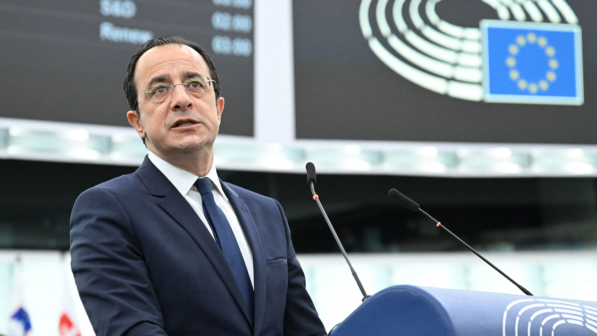 Cyprus President at a lectern on the floor of European Parliament.