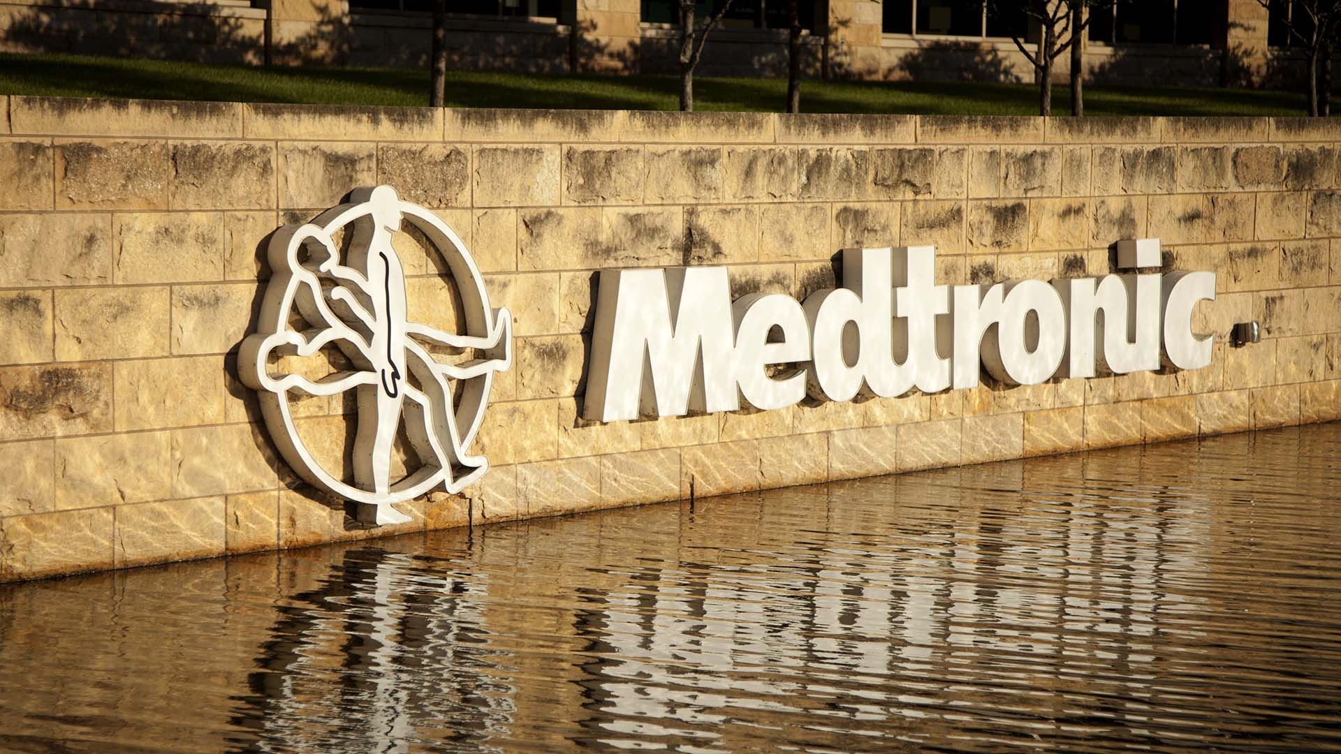 A white Medtronic sign reflected in water