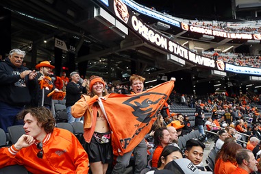 Oregon State students Morgan DeHaven and Caleb Powell cheer for the Beavers before the start of the SRS Distribution Vegas Bowl against Florida Gators at Allegiant Stadium Saturday, Dec. 17, 2022. The students said they drove for 18 hours from Corvallis, Ore. to watch the game.