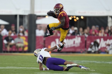 Southern California wide receiver Zachariah Branch (1) leaps over Washington cornerback Thaddeus Dixon (9) during a game  Nov. 4, 2023, in Los Angeles. 

