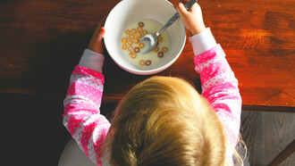 A toddler enjoying a healthy cereal; scientific research has uncovered a fascinating link between the gut and the brain, commonly referred to as the gut-brain axis